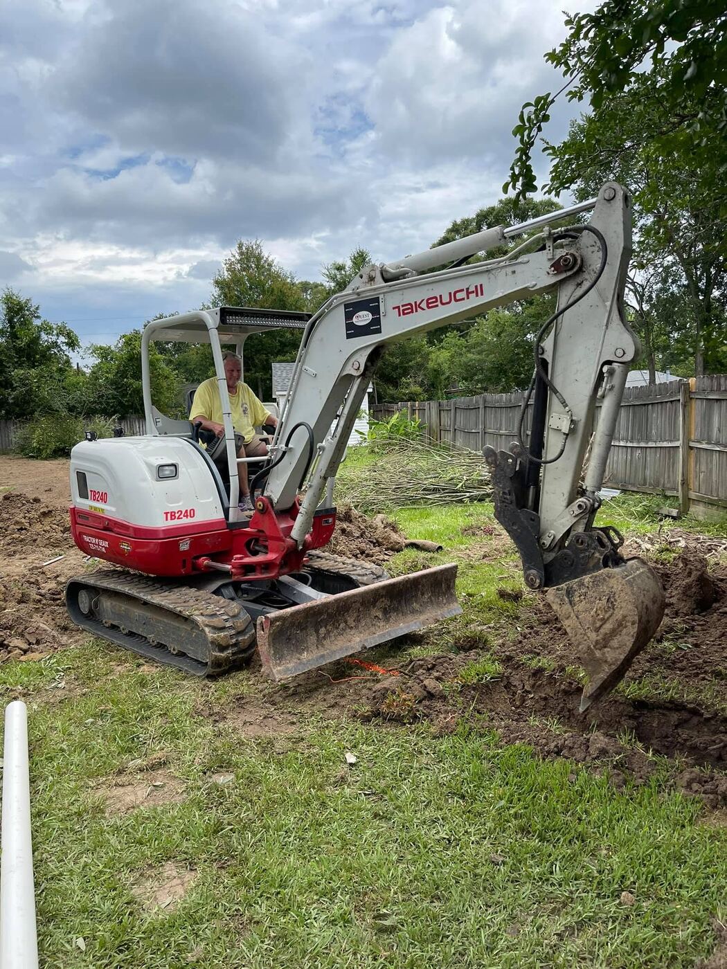 Excavator performing residential dirt work and site preparation