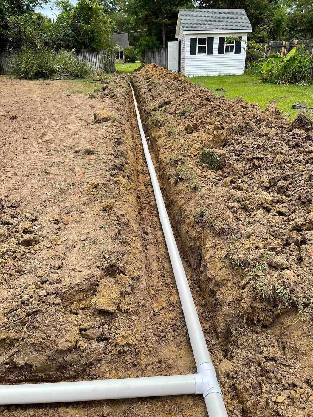 Irrigation line installation trenched through a residential yard