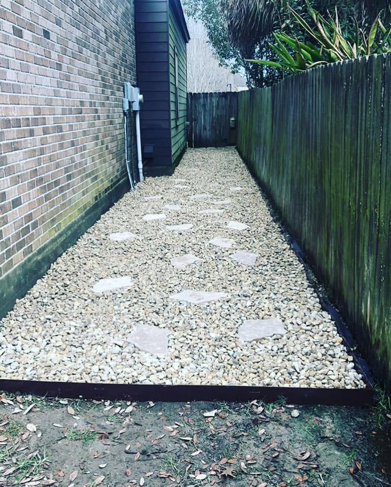 Completed stone path along the side of a home