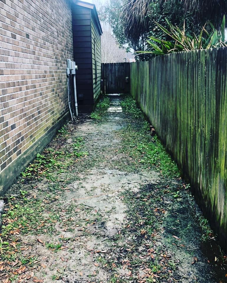 Narrow side yard before the stone path installation