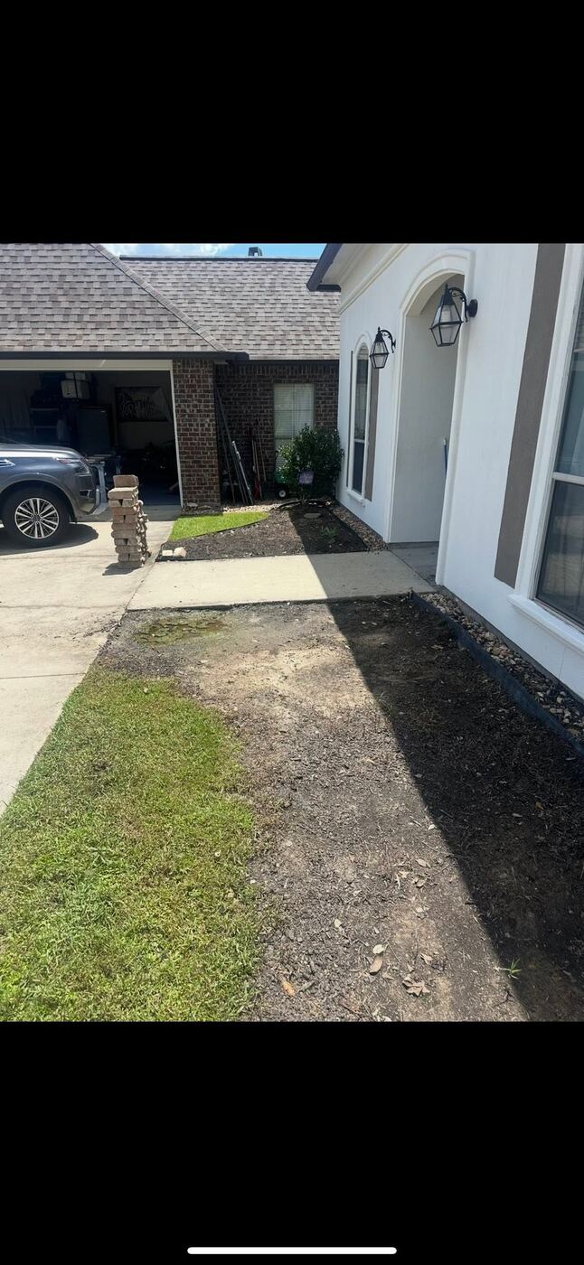 Freshly pressure-washed residential concrete driveway